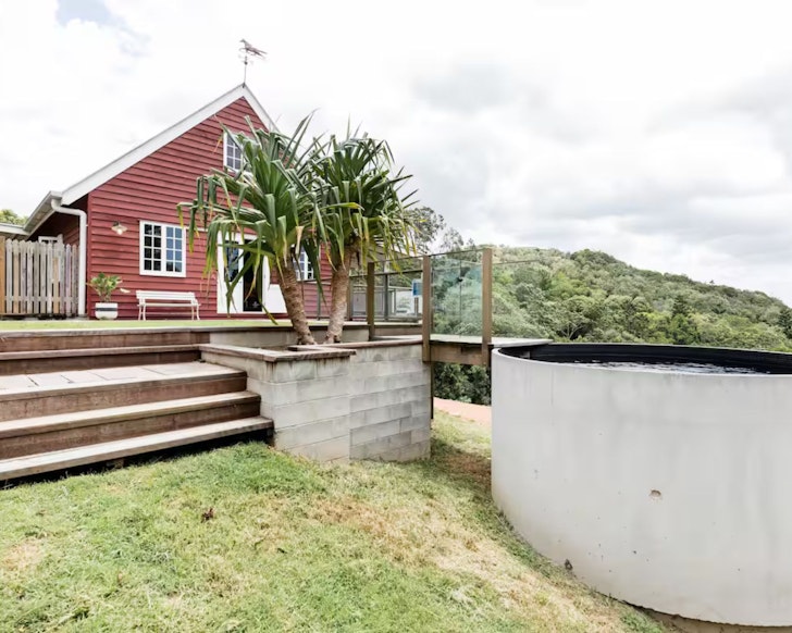 A view of the red barn and the pool at Little Red Barn one of the best Noosa Airbnbs