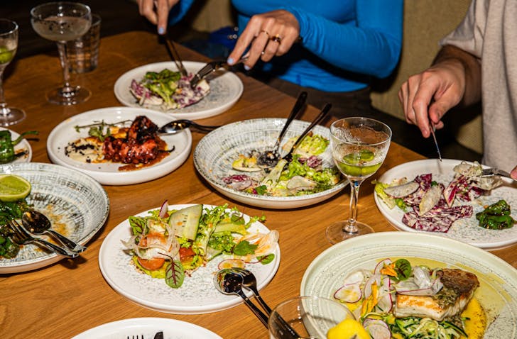 People eating plates of food in Sydney's Surry Hills.