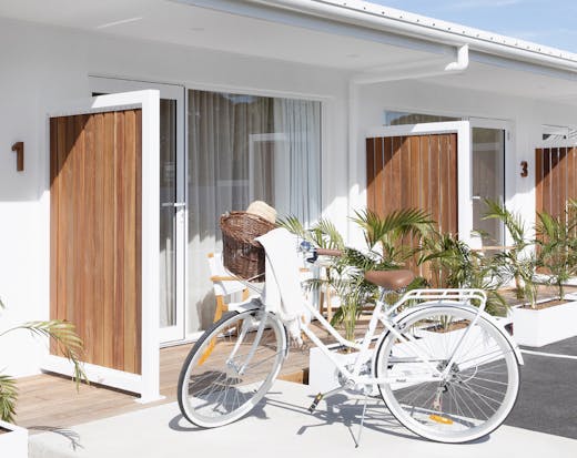 A white cruise bicycle is parked out the front of LOEA Hotel