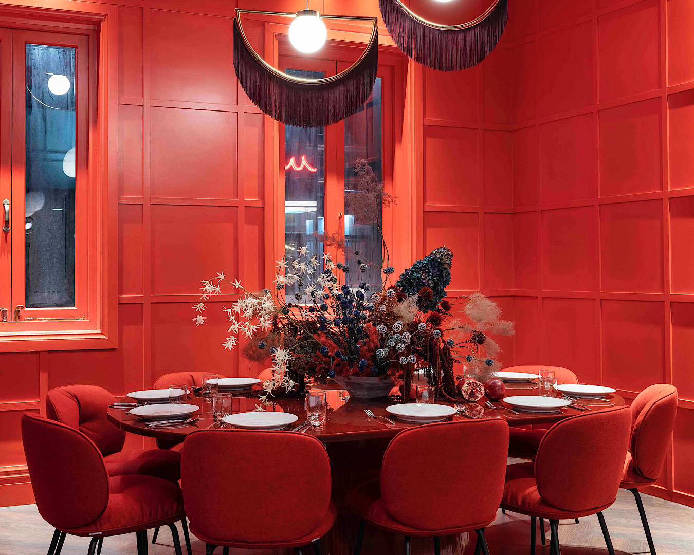 An elegant dining room decked out all in red. 