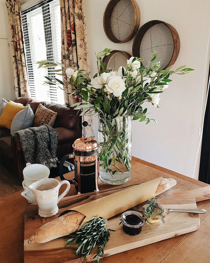 The interior of the charming Longforde Cottage, one of the best airbnbs in NZ with a fireplace.