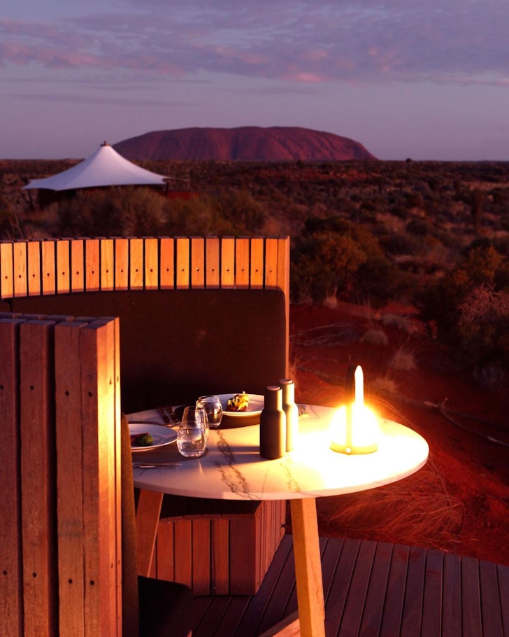 A dining table with a view over Uluru at Longitude 131 one of the best romantic getaways in Australia