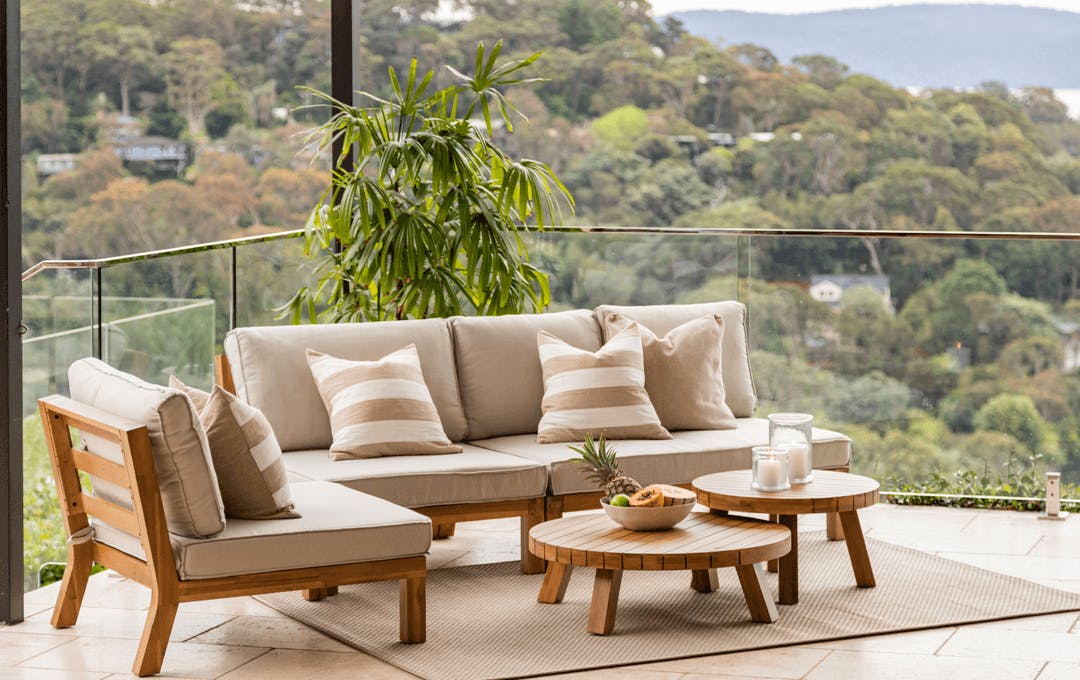 An outdoor couch on a balcony. 