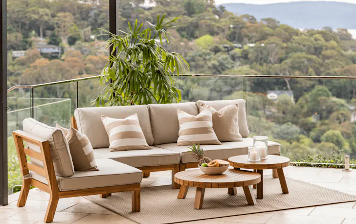 An outdoor couch on a balcony. 