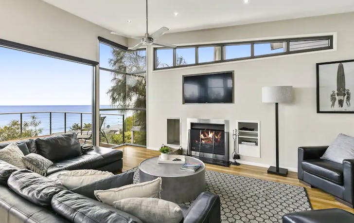 A large lounge room that looks out onto the ocean, a top Lorne accommodation. 
