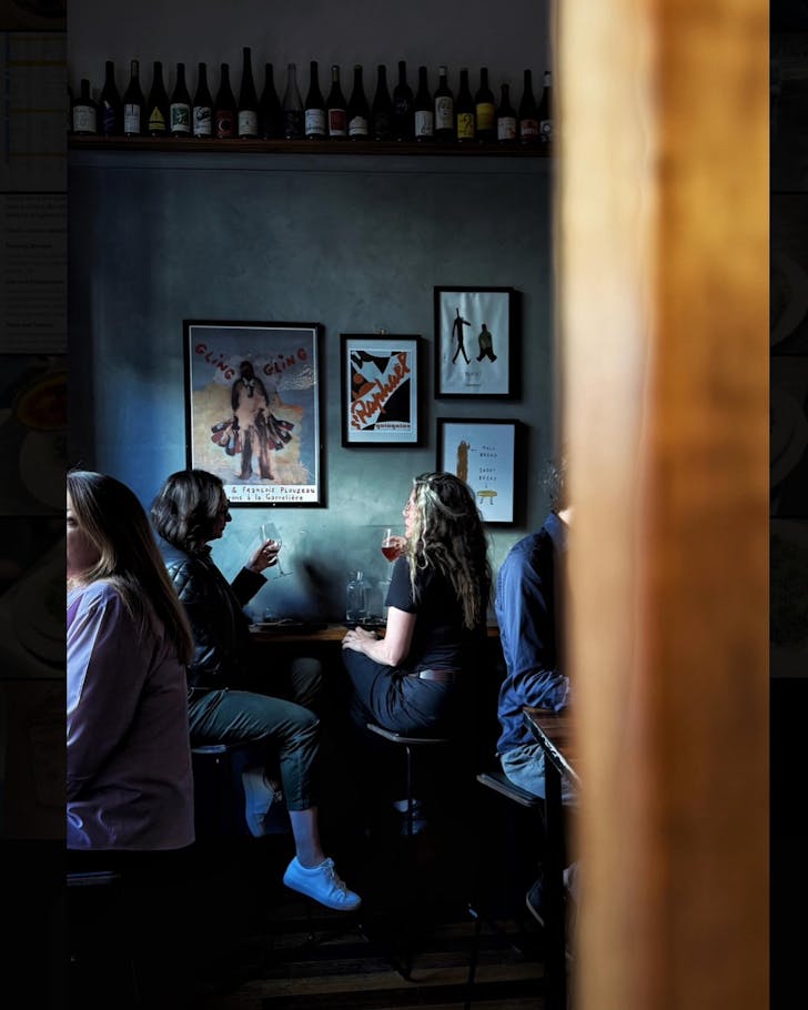 Women sitting drinking in wine bar.