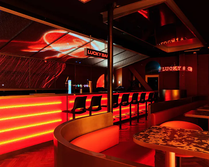 A red neon-lit bar.