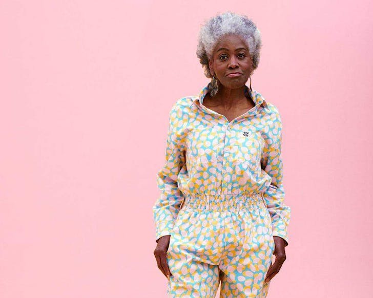 A woman looks confident wearing a cute patterned boiler suit.