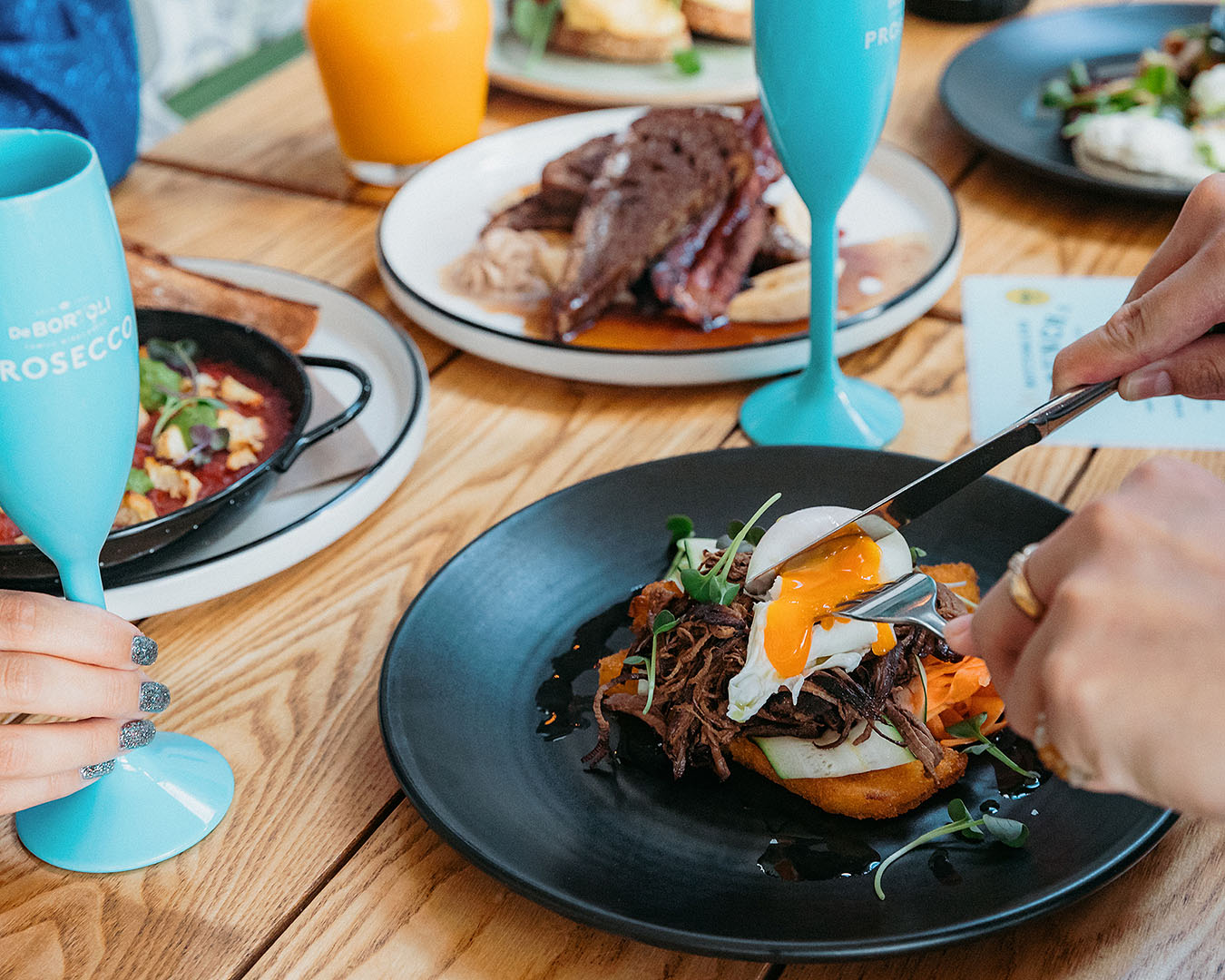 Someone tucks into a delicious brunch at The Lula Inn, one of the best bottomless brunches in Auckland.
