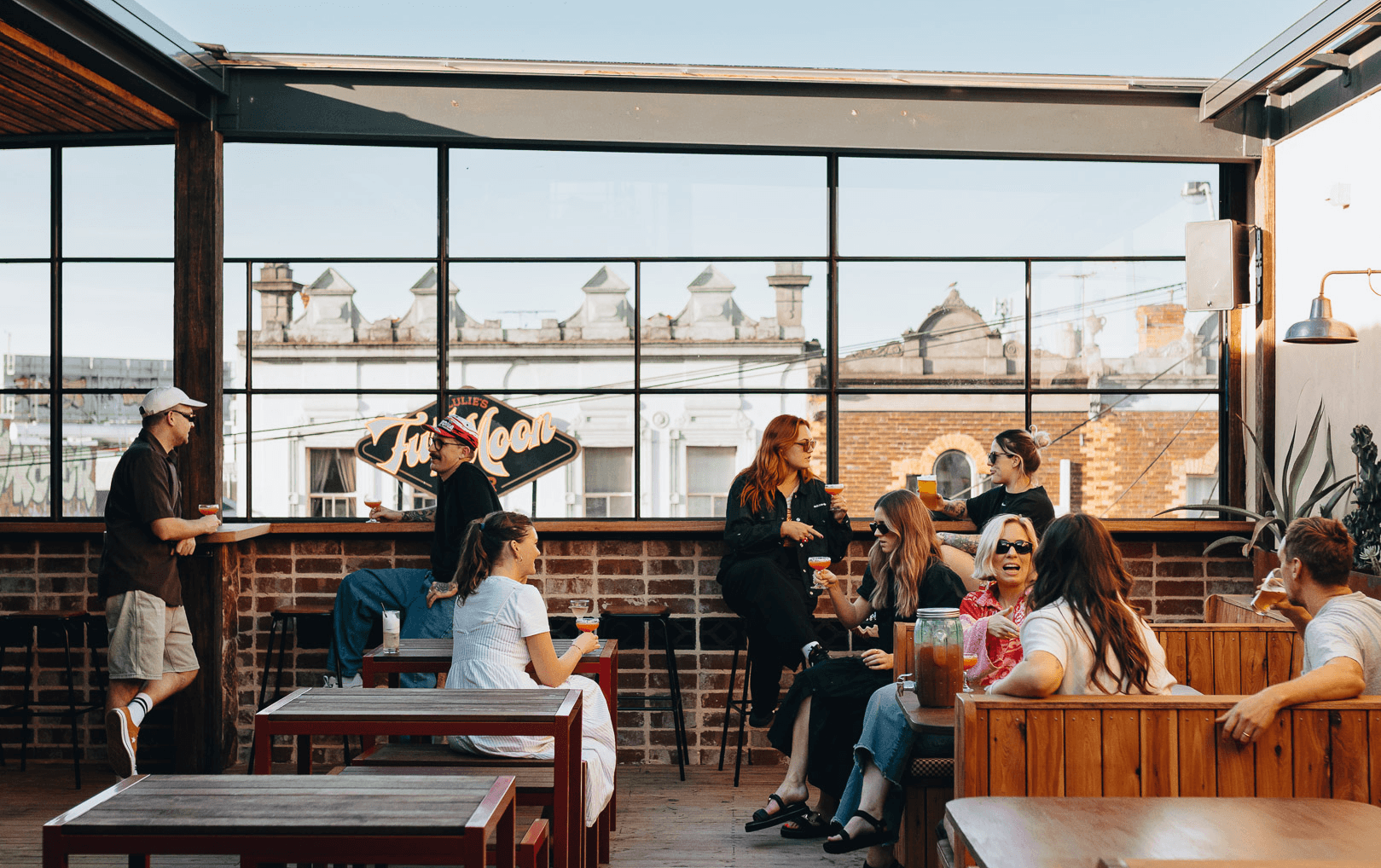 A rooftop packed with people that also serves one of the best burgers Melbourne has to offer