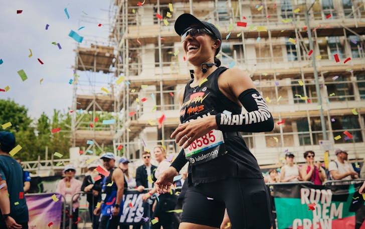 Runner smiling with confetti flying around
