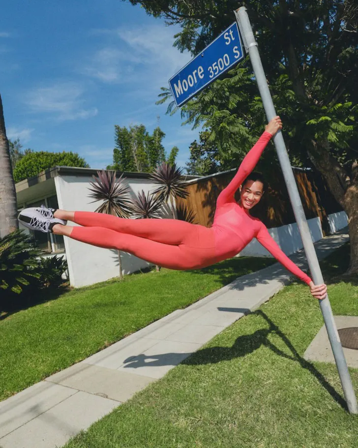 A woman swings on a pole wearing Lululemon clothes one of the best activewear brands