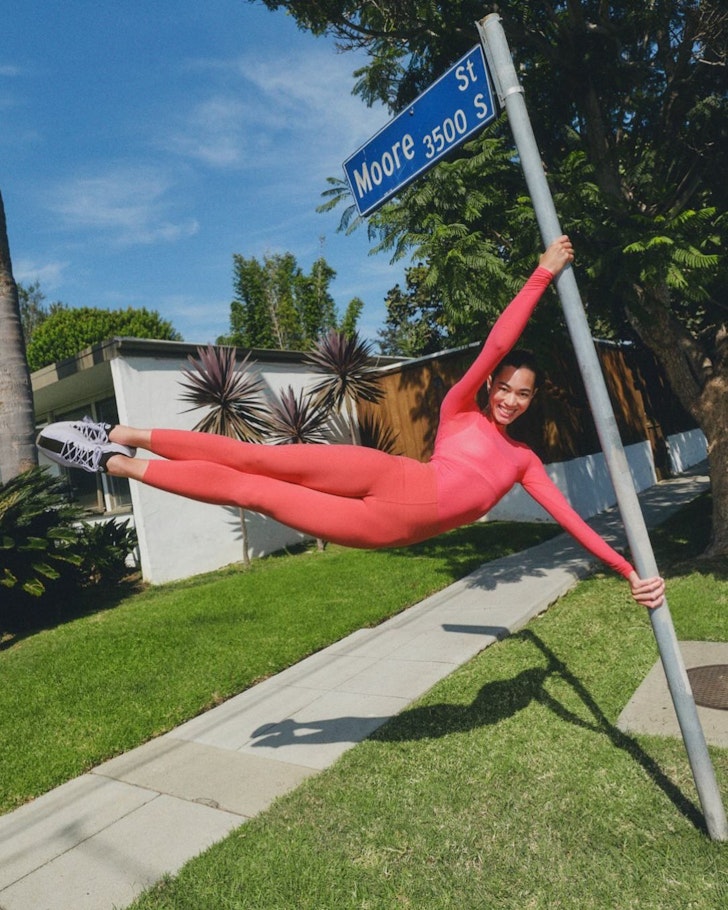 A woman swings on a pole wearing Lululemon clothes one of the best activewear brands