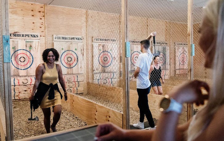 Two people doing axe throwing in Melbourne. 