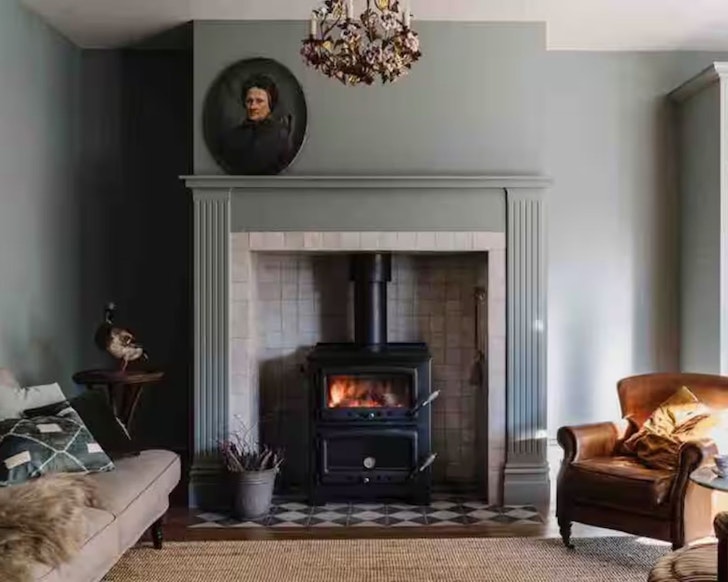 The living space with artwork and an indoor fire at Lumiere Lodge one of the best Airbnbs in Hobart 