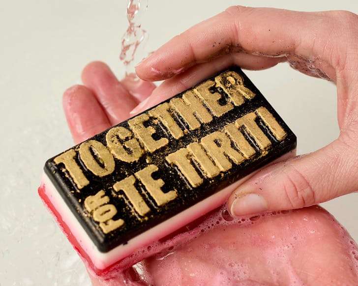 Washing our hands with Lush's pocket-sized black, red and white Together for Te Tiriti soap.