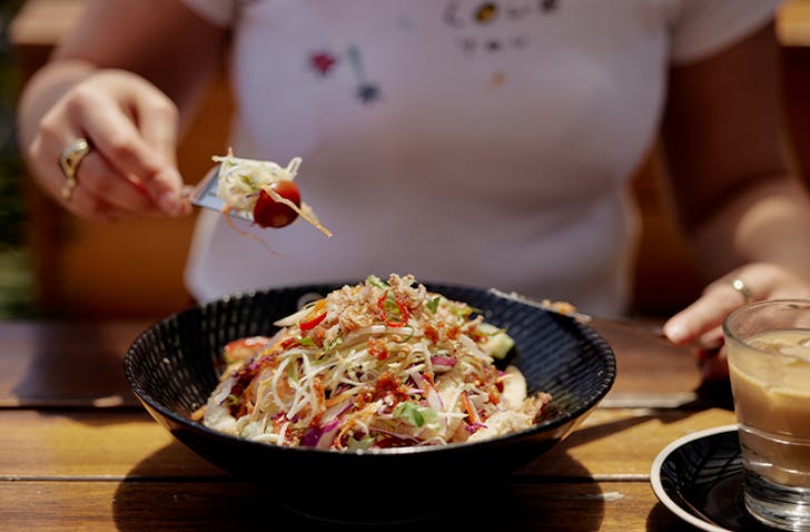 A person eating one of the best breakfasts in Melbourne at Lux Foundry