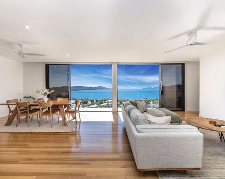 A view of the living and dining space looking out to the sea at Luxury Holiday Villa B Airbnb one of the best Townsville stays