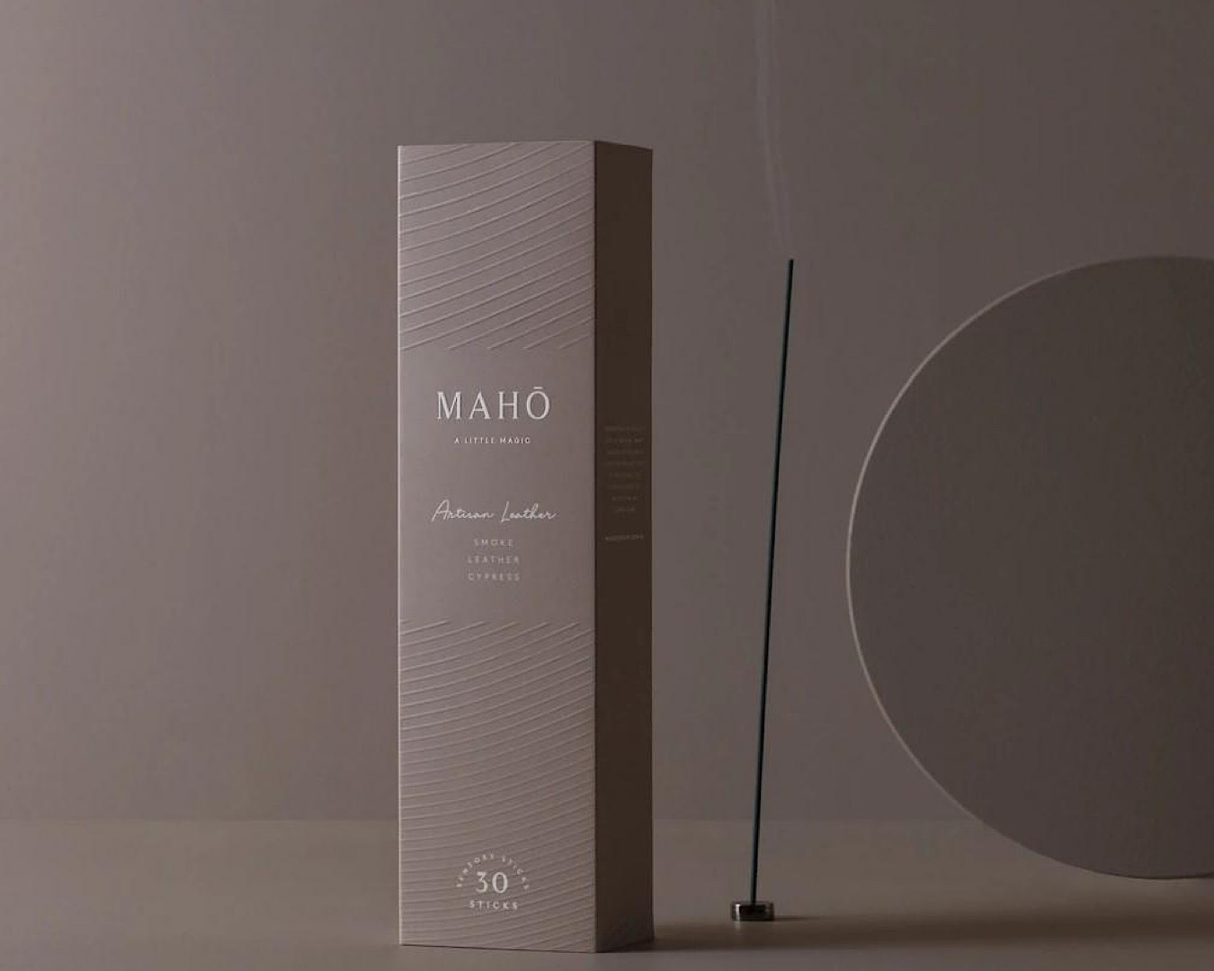 A stick of incense quietly burns beside a silver box that says ‘MAHŌ a little magic’. 