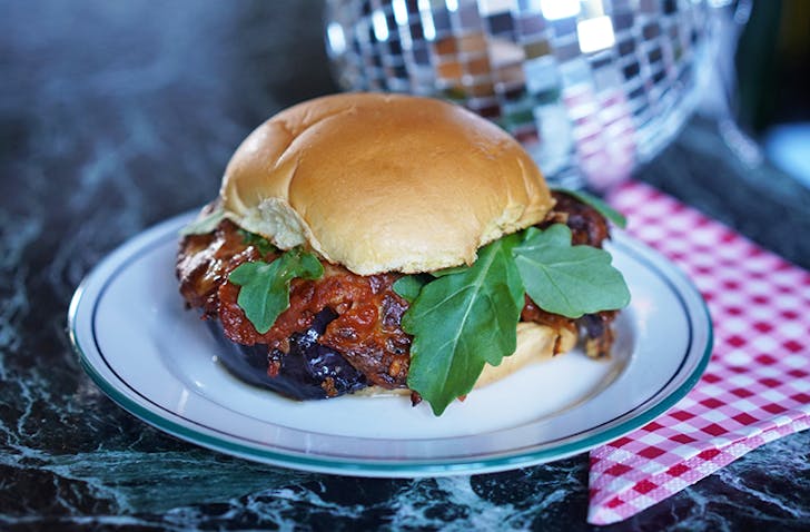 Rocco's melanzane sandwich dripping with red sauce and stuffed with fried eggplant