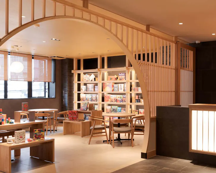 The games room at MIMARU Osaka is packed full of board games with warm, timber interiors.