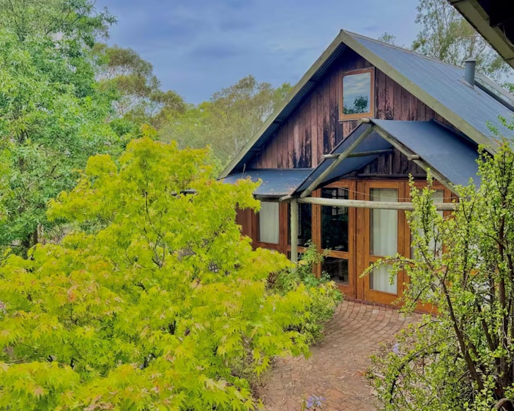 An exterior view of Maccy's Cottage with it's pointed roof, one of the best pet-friendly Airbnbs near Adelaide