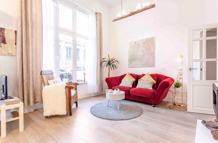 a madrid airbnb lounge with a red couch