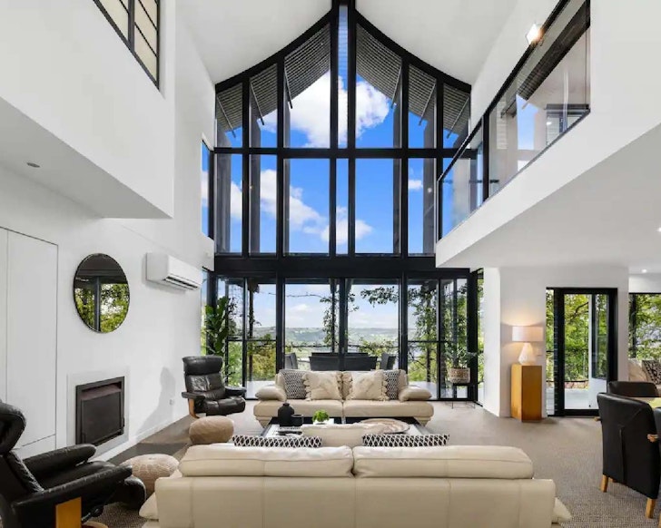 Living room with floor to ceiling windows overlooking mountains