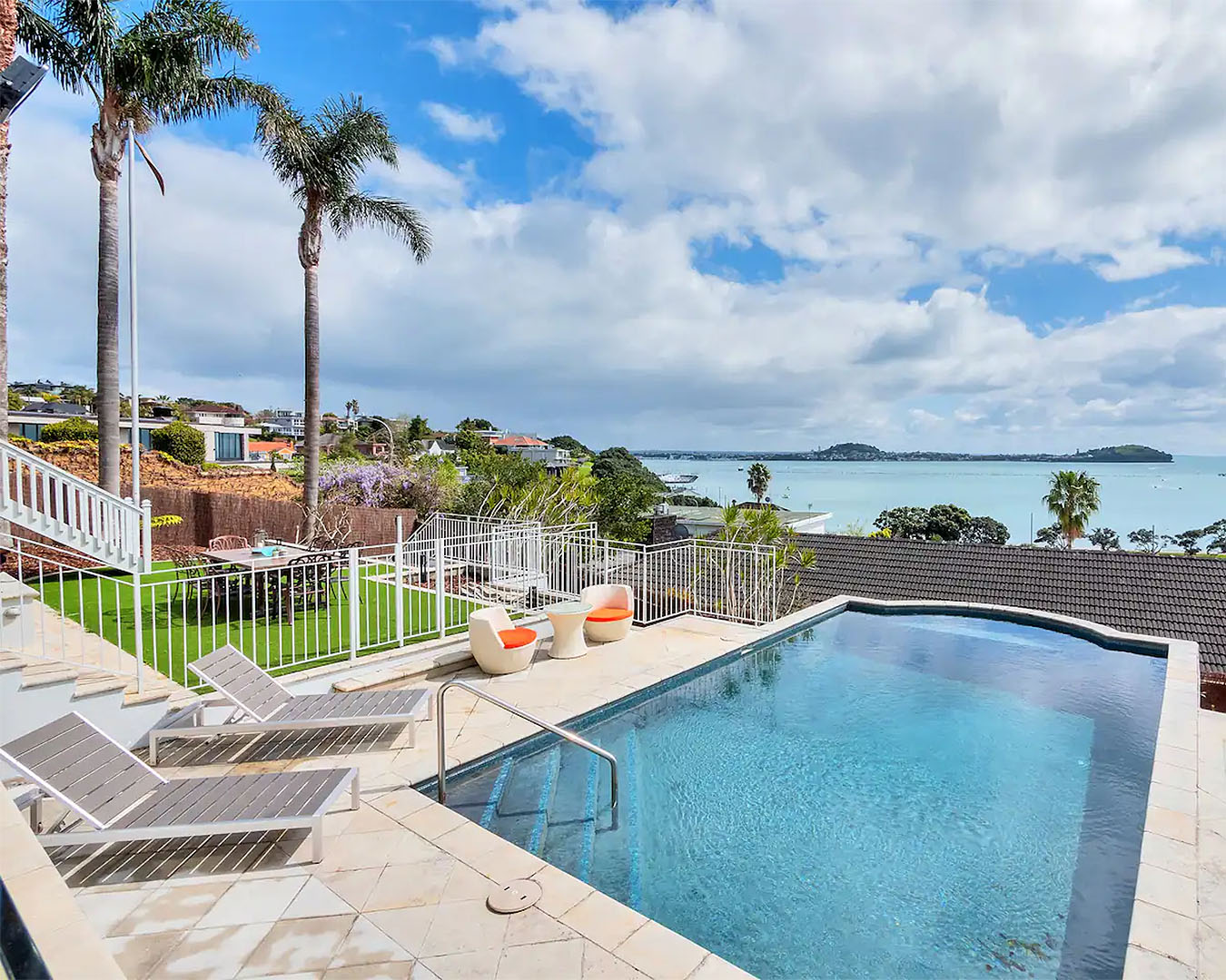 Palm trees overlook this stunning airbnb with pool in Remuera, one of the best airbnbs with pools in Auckland.