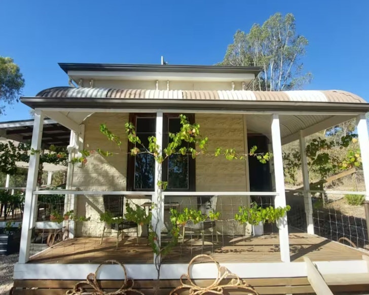 The vine-covered exterior of Magpie Lane Cottage one of the best Clare Valley accommodation options