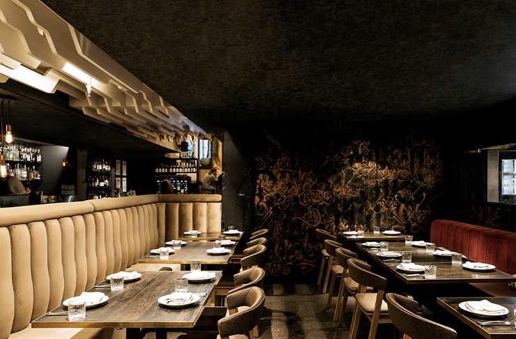 A dimly-lit dining room at Maha Restaurant, hosting a mother's day in melbourne lunch