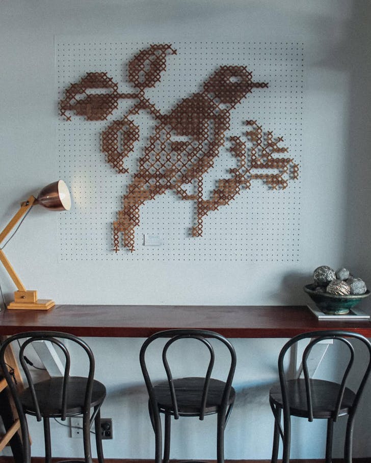 A bird artwork (possibly a myna) takes centre stage at Maina. 