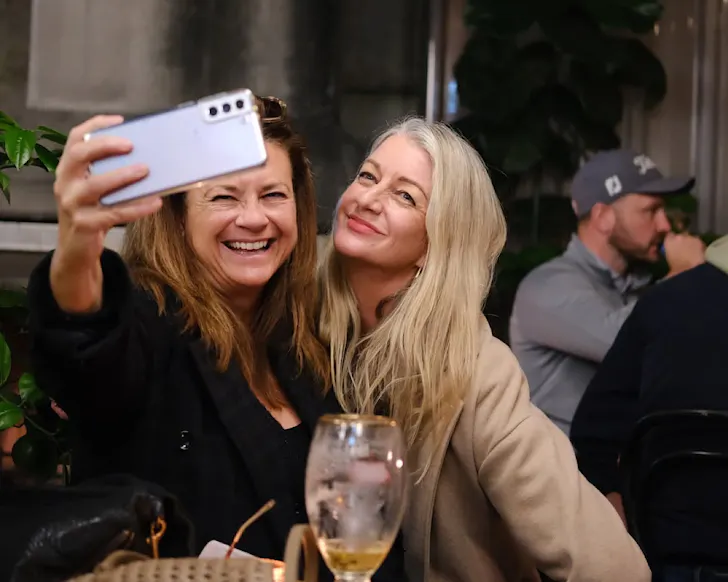 Two smiling women take a selfie.