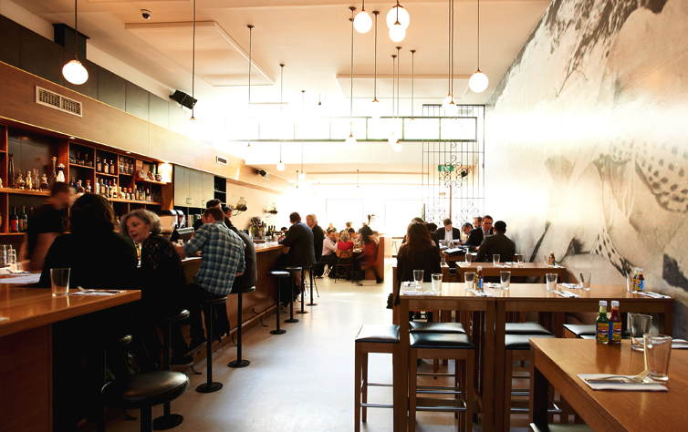 A light-filled diner and bar with people at one of the best Mexican restaurants in Melbourne.