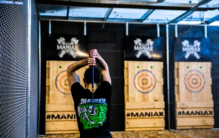 A person tossing an axe at the best axe throwing in Melbourne. 