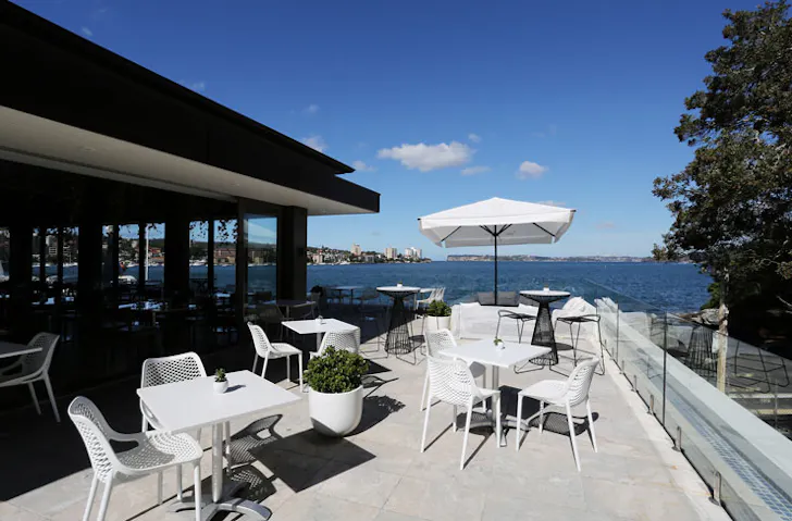 The sun-filled balcony at Manly Pavilion, with a blue sky in the background. 