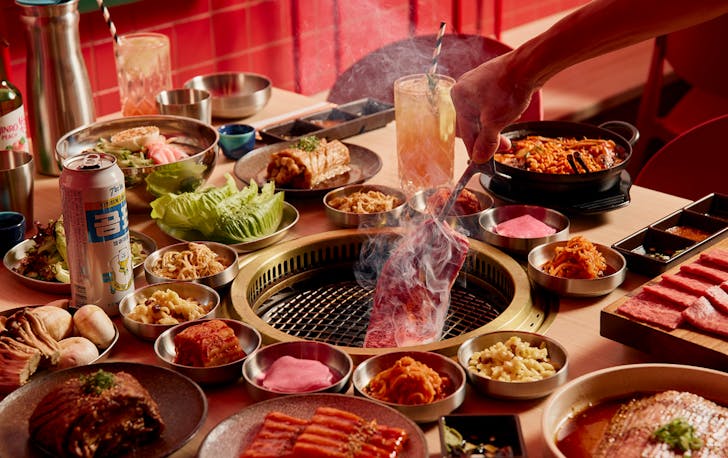 A person cooking a piece of premium wagyu over one of the best korean restaurants in melbourne