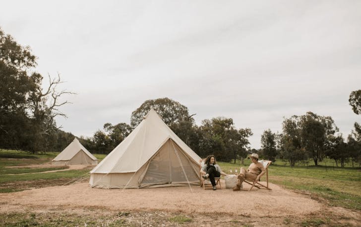 Two people sitting out front some of the best glamping victoria