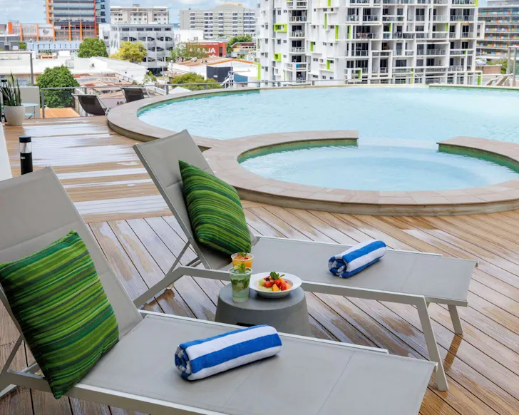 A view of two sun loungers by the pool at Mantra Pandanas one of the best Darwin hotels