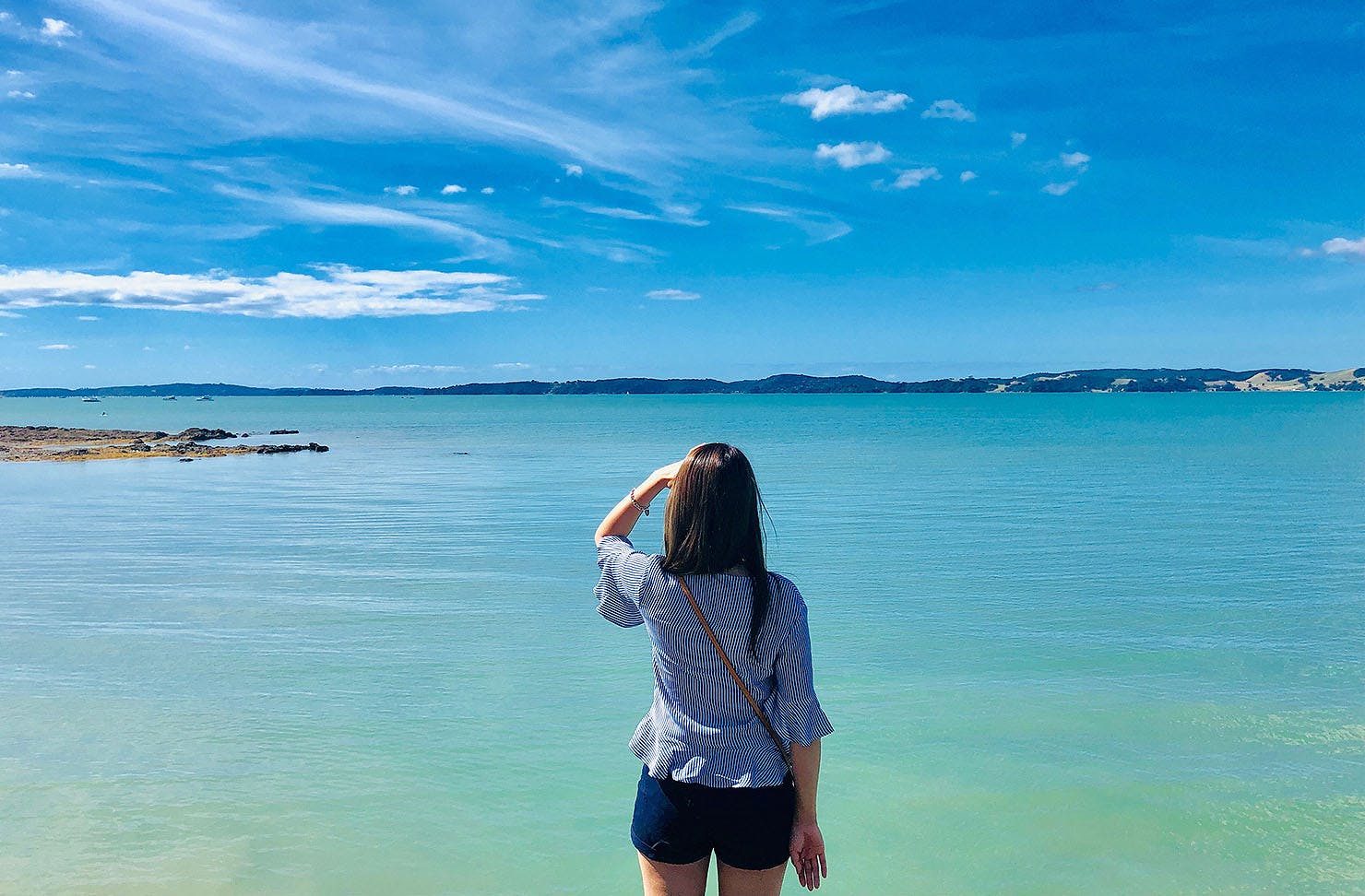Rear View Of Woman Looking At Sea Against Sky in Maraetai.