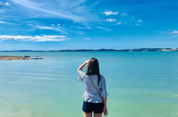 Rear View Of Woman Looking At Sea Against Sky in Maraetai.