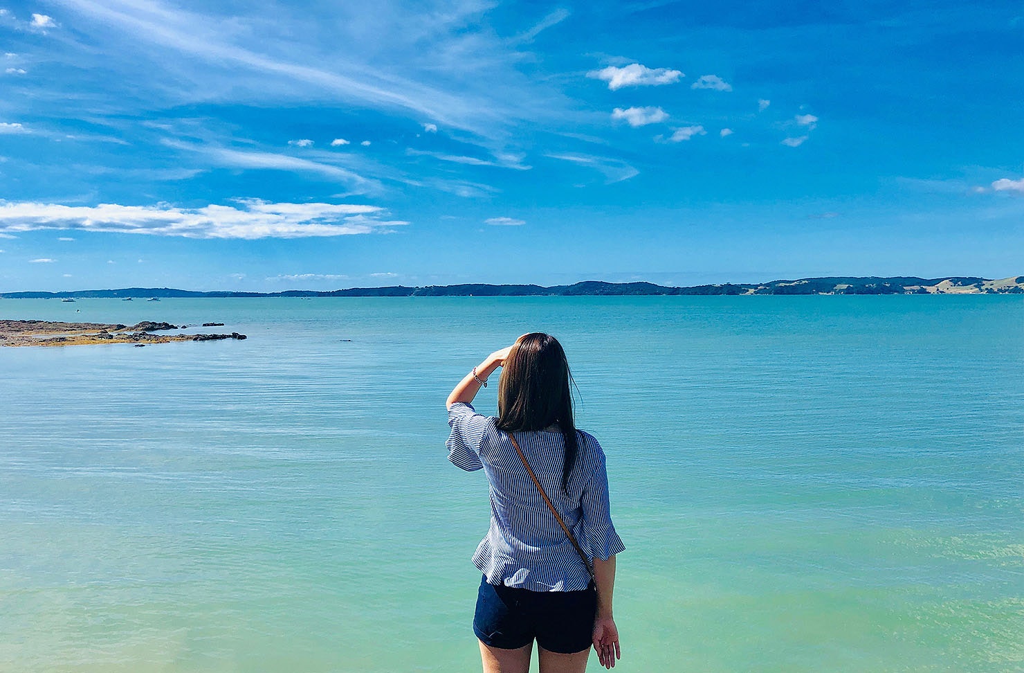 Rear View Of Woman Looking At Sea Against Sky in Maraetai.
