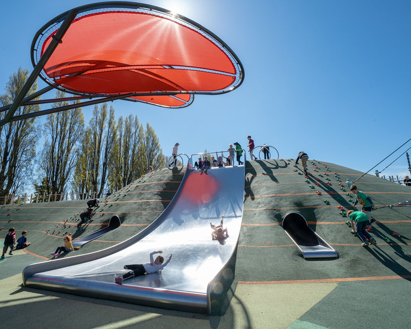 People enjoy the slide at Margaret Mahy Playground in Christchurch, one of 50 of the best things to do.