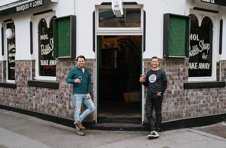 Two people holding beers at one of the best pubs in Fitzroy. 