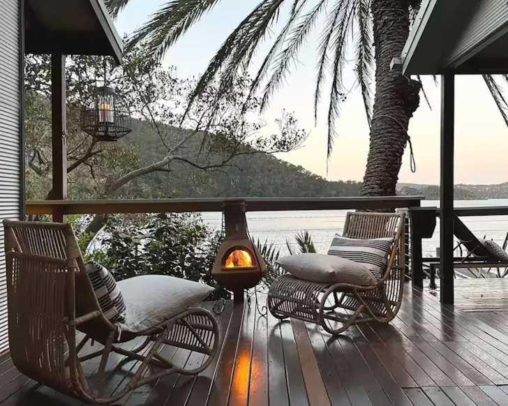 Two chairs next to the fire pit at Marramarra House romantic Airbnb NSW