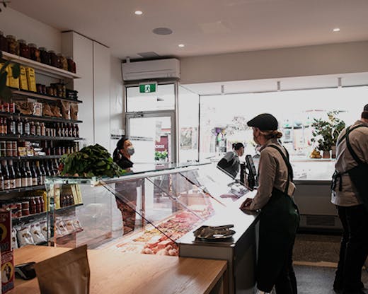 The inside of the butcher with a person being served.