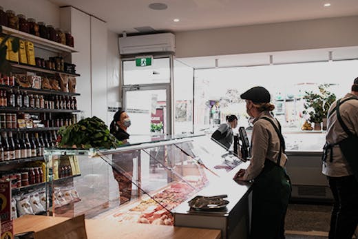 The inside of the butcher with a person being served.