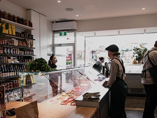 The inside of the butcher with a person being served.