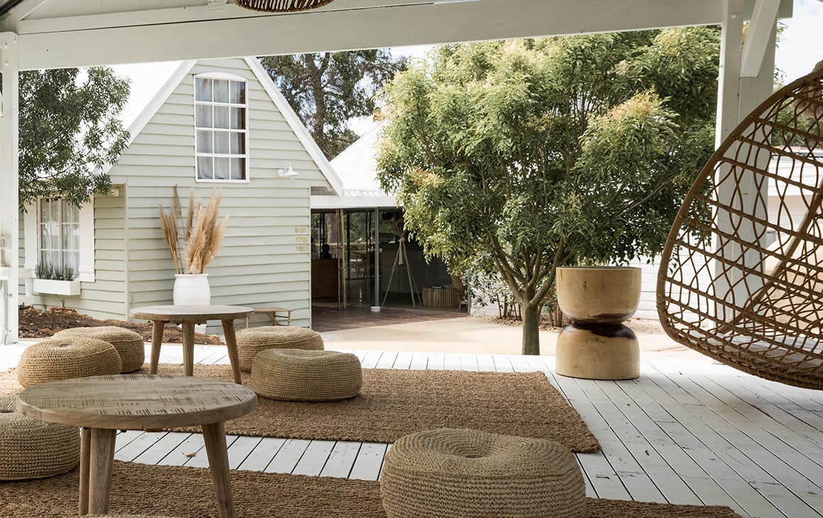 Meelup Farmhouse's deck with cushions and a hanging egg chair