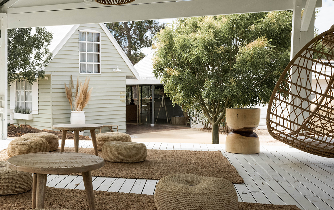 Meelup Farmhouse's deck with cushions and a hanging egg chair